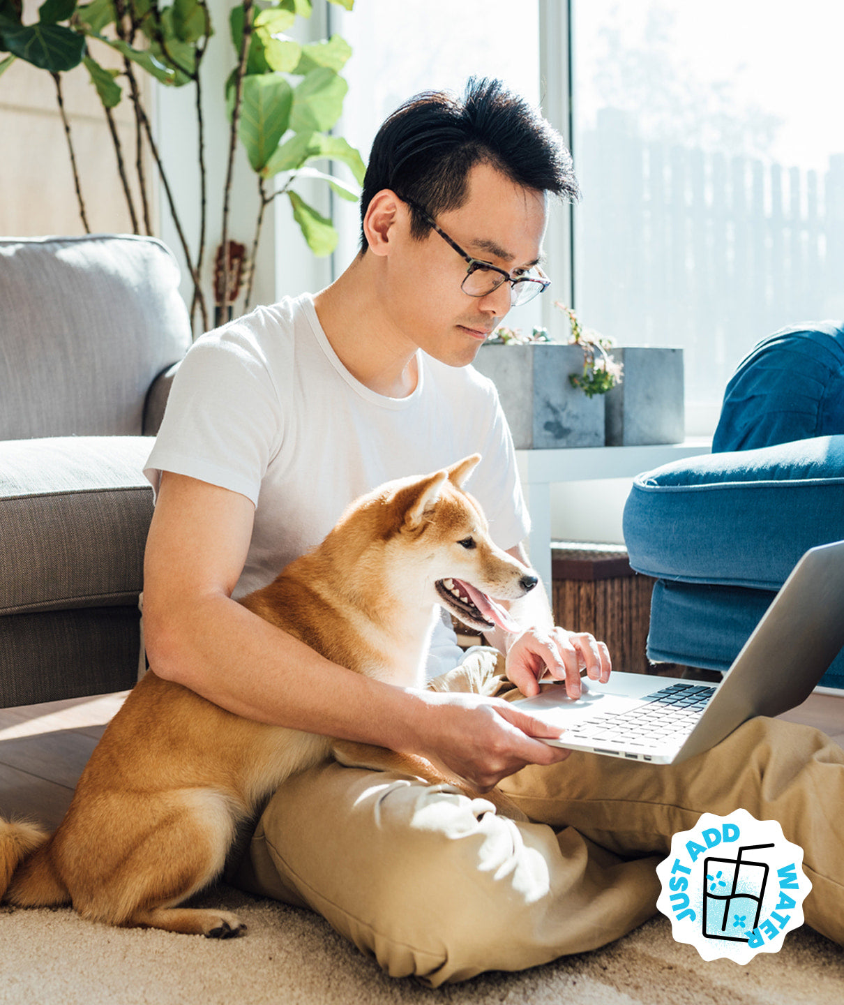 Man working on his laptop with his dog